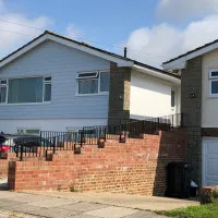 An image showing a metal hand rail we created for the ramp outside a house